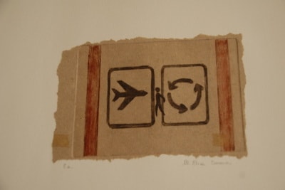 Cardboard shipping label with airplane and fragile symbols — print on found material by Elisa Sassera